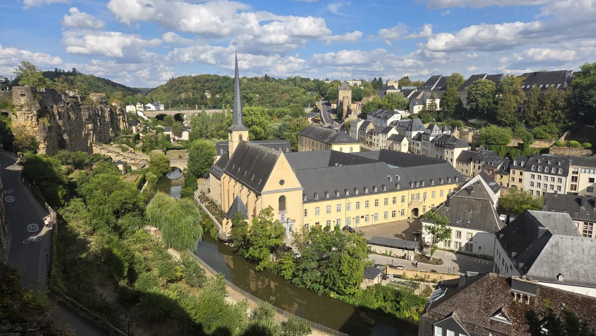 Depuis la corniche, on plonge dans le quartier du Grund. Au bord de la rivière Alzette, trône l'ancienne abbaye bénédictine qui est aujourd'hui un centre culturel.
